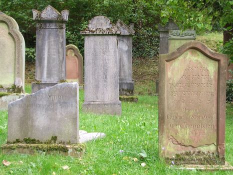 Weathered gravestones on an old jewish cemetery in Germany