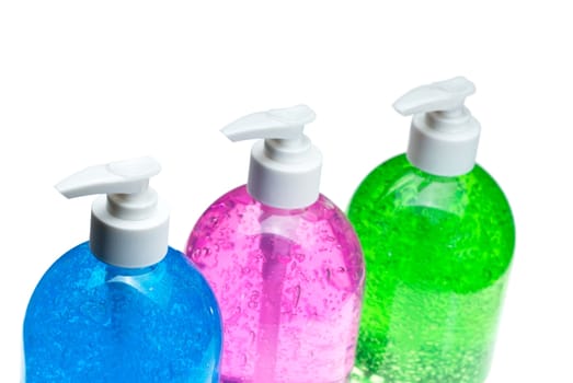 colorfull blue,pink and green hair gel bottles over white background