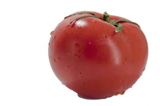 fresh red tomatoes in a heap on a light background