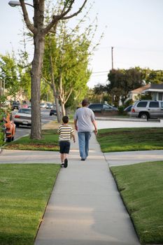 Father and son enjoying quality time walking around the neighborhood