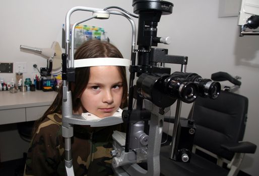 Young girl anxiously waiting for her eye exam