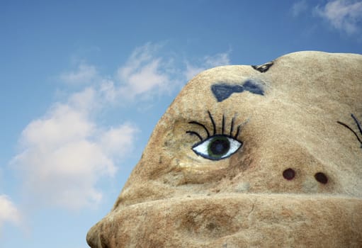 A face painted on a rock