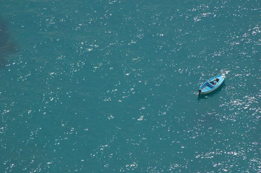 Wood boat in the blue sea