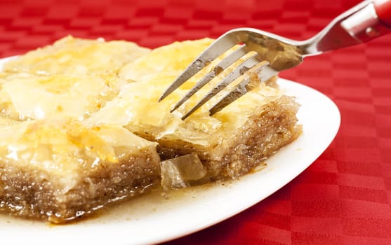 Traditional Turkish dessert Baklava - served in white porcelain dish