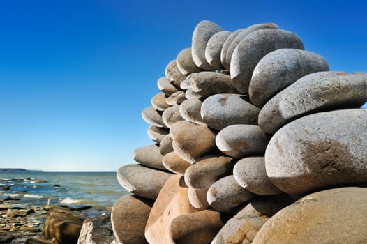 large quantity cobblestones one on another on sea coast