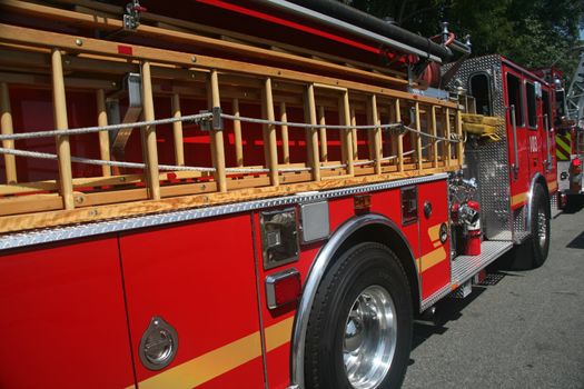 Side of a bright red fire engine stopped on the street