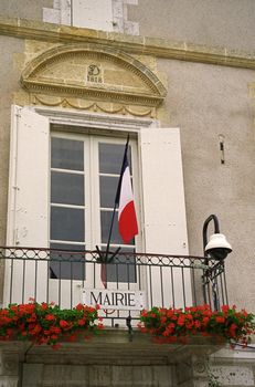 The French flag adorns the early nineteenth century mayor's office at Larressingle SW France