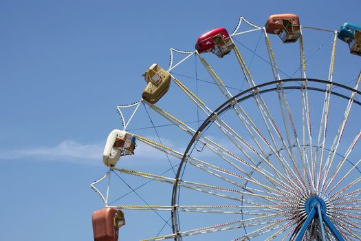 Carnival ferris wheel with blue sky background