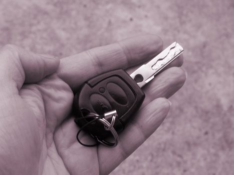 handing over the car key to the driver of the car
