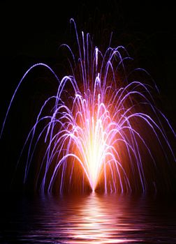 Colorful and beautiful display of fireworks over water