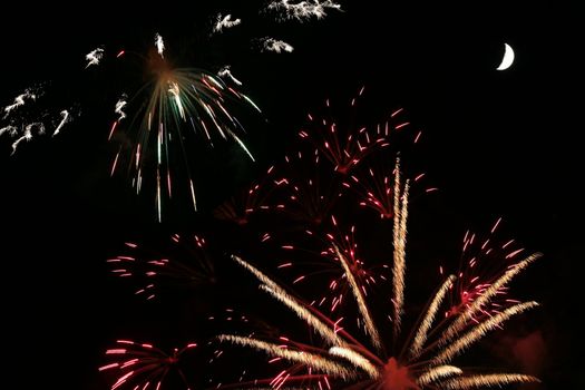 Colorful fireworks with moon in the background