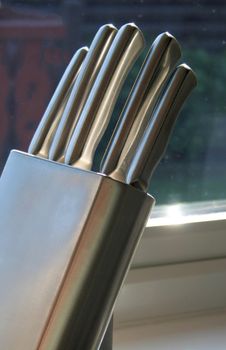 stainless steel knives in a knife block