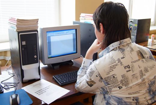 Closeup of man working on computer - face looking at monitor