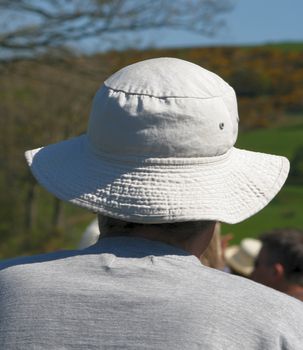 a sun hat for protection against the sun keeping this man in the shade