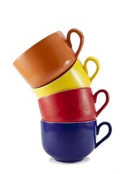 four differently colored cups on white background