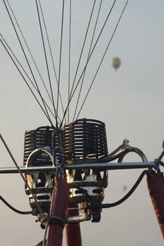 detail photo of balloon burner, two balloons blurred in background