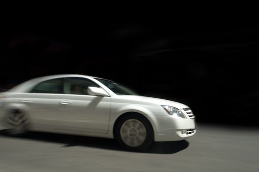 white car in speed, motion blur, black background