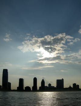 vertical photo of new jersey skyscrapers silhouettes, viewed from manhattan