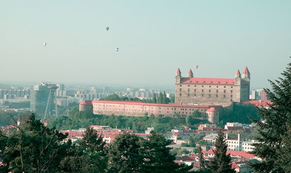 famous bratislava castle, flying balloons in background, cold autumn colors