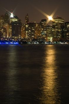night shot of new york city, lower manhattan, lights reflection in hudson river, photo taken from new jersey