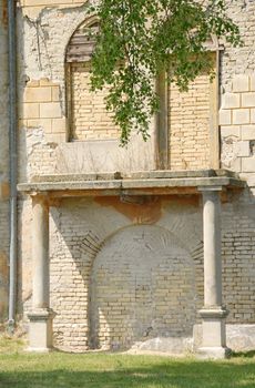 old brick wall with blind windows and doors