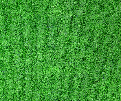 A green artificial grass for sports fields, covering, gardens. Plastic or grass backgroung texture