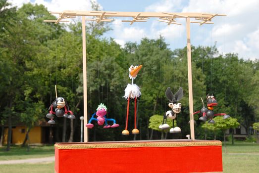 puppets animals hanging on wooden slat outdoor