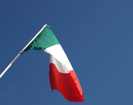 Flag of Italy over blue sky background