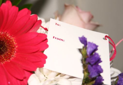 blank card on a bouquet of flowers  