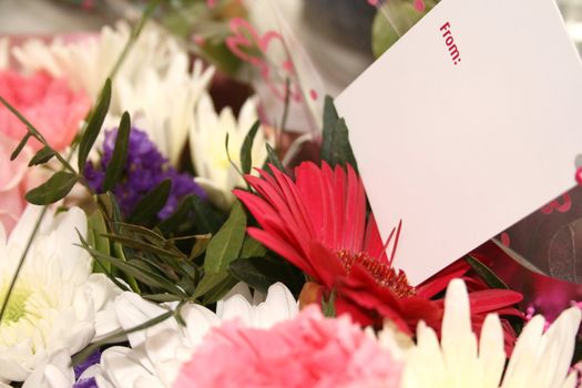 blank card on a bouquet of flowers  