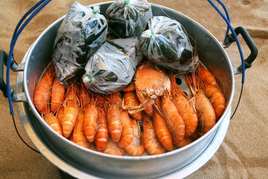 Royal prawns in aluminum saucepan on song