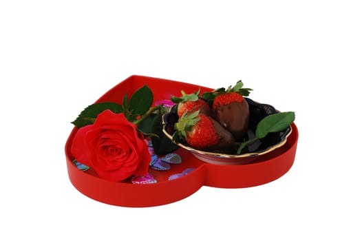 Strawberries in chocolate on red heart shaped tray with rose isolated on white background