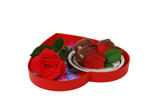 Strawberries in chocolate on red heart shaped tray with rose isolated on white background