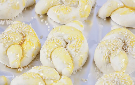 Buns on aluminum foil prepared for baking