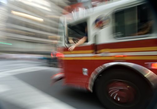 red fireman truck in motion, photo taken in new york