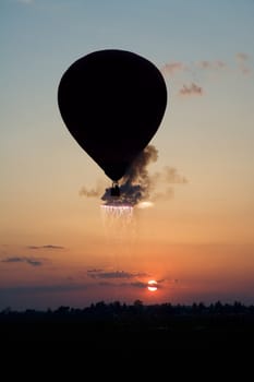 hot air balloon flying above ground, pyrotechnics effects