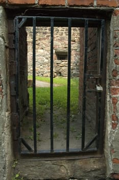 latticed entrance to an old brick prison