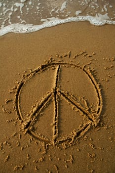 peace sign on a beach, in a moment water will wash it away, dusk photo