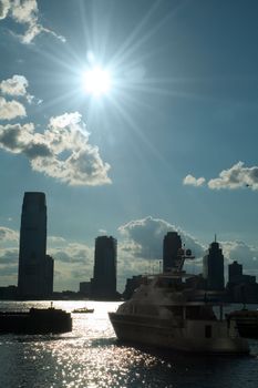 big luxurious yacht silhouette, photo taken from new york, new jersey in background