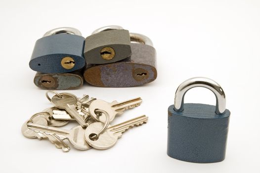 several different locks and keys on white background