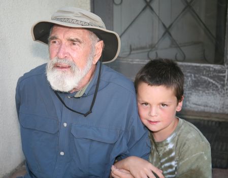 Grandpa and grandson sitting on porch