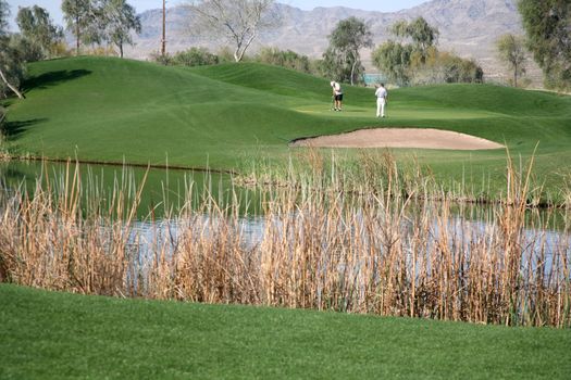 Golf course with golfers enjoying a healthy lifestyle