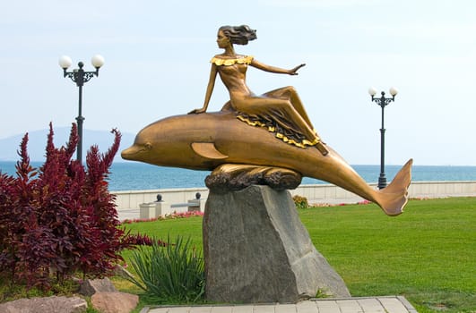 Sculpture of  dolphin and  girl on  waterfront in Novorossiysk, Russia.