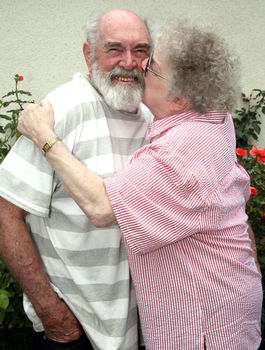 Grandmother kissing her husband