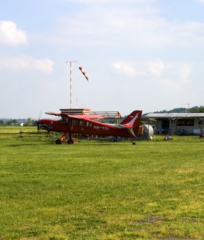 Old red plane seen from left side