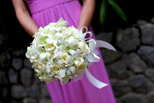 Close-up of a bridesmaid holding a beautiful bouquet.