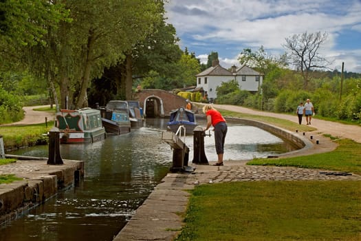The lock is made ready for the narrow boat to enter on the Trent and Mersey canal in Staffordshire, England.