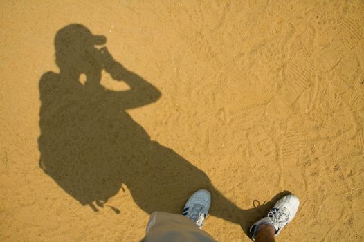 photographer shadow on baseball field