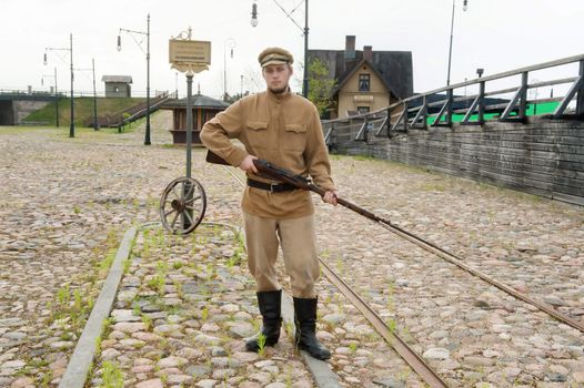 Soldier with a gun in uniform of World War I. Costume accord the times of World War I. Photo made at cinema city Cinevilla in Latvia.