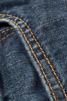blue jeans detail photo, orange needlework